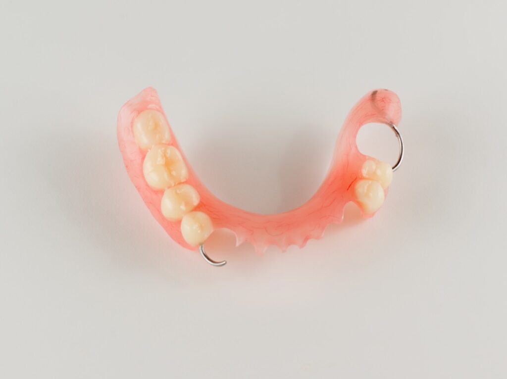 acrylic denture with metal clasps for restoring dentition